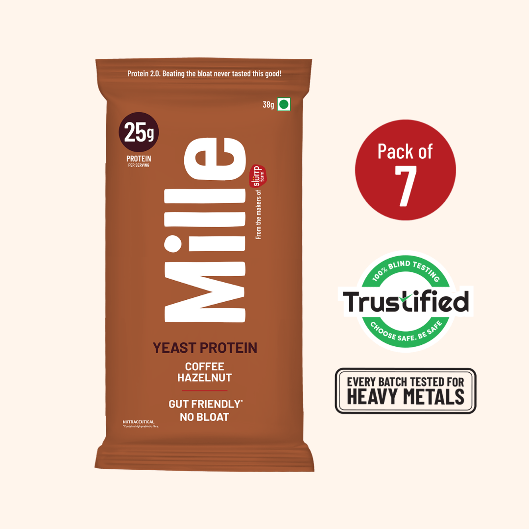 A single Mille Yeast Protein bar package in brown stands on a light beige background, with a red circle indicating 'Pack of 7' and Trustified and heavy metal testing badges to the right.