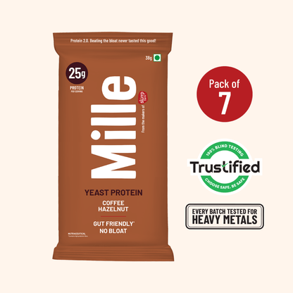 A single Mille Yeast Protein bar package in brown stands on a light beige background, with a red circle indicating 'Pack of 7' and Trustified and heavy metal testing badges to the right.