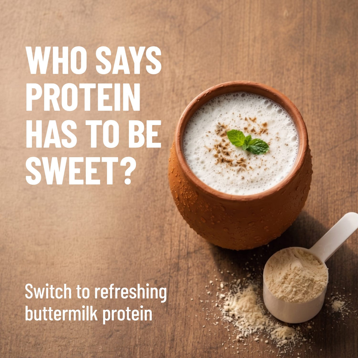 Protein shake in a terracotta cup with buttermilk protein powder on a wooden surface.