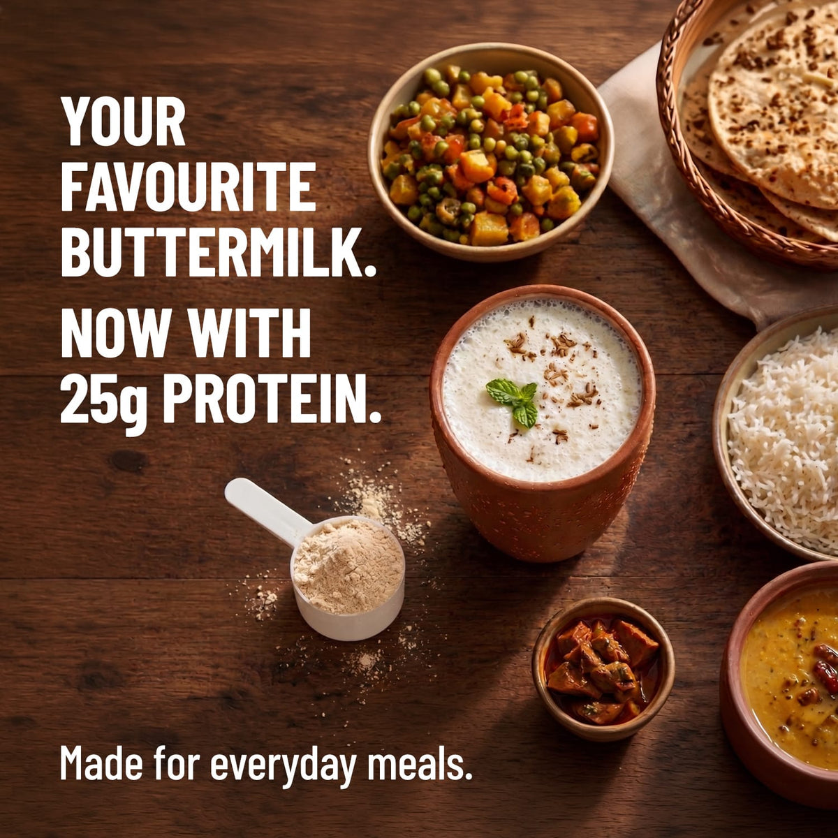 Buttermilk with protein supplement on a wooden table with food items.