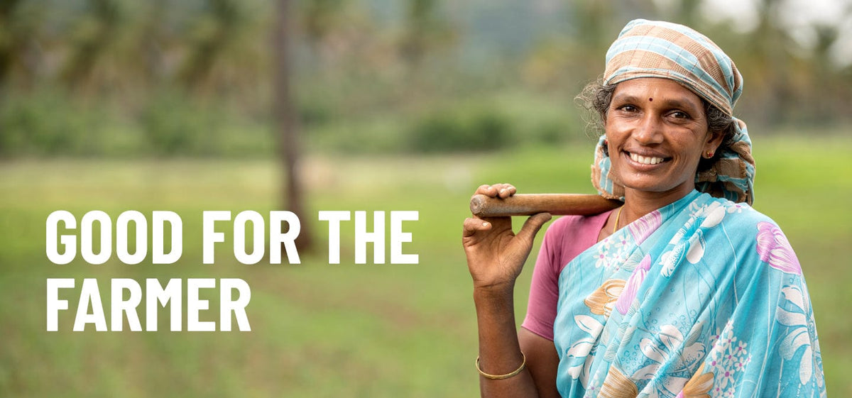 Woman in a blue sari holding a tool in a field with 'Good for the Farmer' text.
